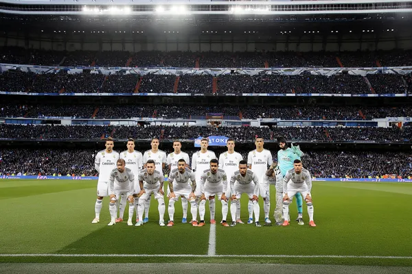 A woman in a luxurious green gown next to an ornate roulette wheel, capturing the upscale casino mood of REAL MADRID.