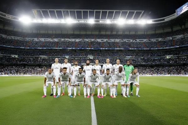 A player using their smartphone during a festive local event, representing REAL MADRID’s fully mobile-friendly casino.