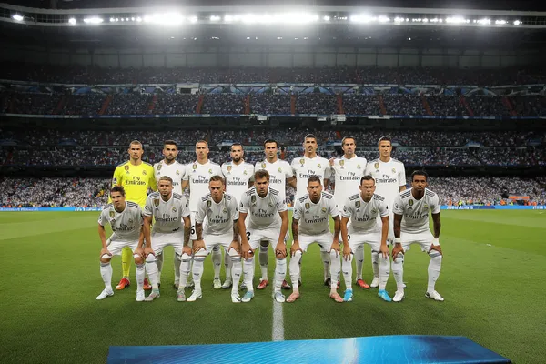 A laptop glowing with a bright login prompt in a minimalistic setup, symbolizing the protected access system at REAL MADRID.