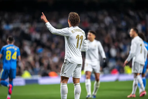 A person using their device against a moody casino-themed background, illustrating the smooth re-entry process at REAL MADRID.